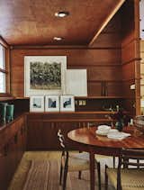 The main dining area—another space dressed in custom woodwork—sits near the kitchen.