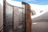 The outdoor shower, an addition by Richard, is framed with more screens created by artist Greg Reich. The slabs of rough stone were milled in New Mexico.