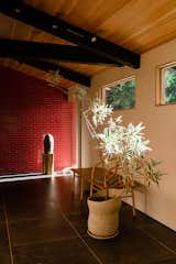 The red masonry wall partially hides the interior from the entryway.