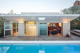 Set behind the couple’s Silver Lake home, the two-story structure has a crisp white board–and–batten exterior.  Photo 3 of 13 in A Composer and Fashion Designer Add an Inspiring Creative Space to Their Los Angeles Backyard