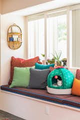 Jamie designed the cushions and pillows for the built-in bench, where the couple’s cat, Alfredo, often lounges.&nbsp;