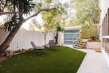 The fenced-in side yard is a private outdoor oasis, complete with newly laid turf.
