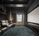 Sleek textures continue into the theater, which has wool Holland &amp; Sherry upholstered walls.