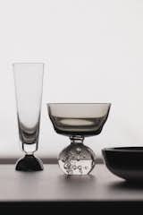 Small high-wall Sera plates are joined by black and white stemware.