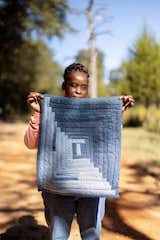 Quilter Andrea Pettway Williams displays a work of her own making.