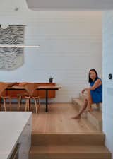 Hanna commissioned the Julia Canright tapestry hanging above a midcentury credenza. Cherner dining chairs are paired with a custom steel table with a live-edge acacia wood top from Ponderosa Millworks.  Photo 4 of 11 in An Unorthodox Houseboat in Sausalito Gives Its Owner Permission to Play