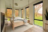 The primary bedroom is "almost like two bedrooms in one,  Photo 9 of 13 in This Charming Kalamazoo Farmhouse Has a High-Tech Secret