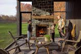 Kirt says one of his favorite spaces in the house in the screened porch with wood-burning fireplace.