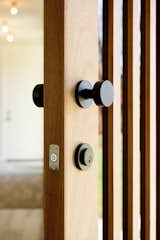 When customizing the front door, clean vertical lines and simple hardware were the top priorities for the Stauffers. The Level Bolt was able to make the existing lock smart while also maintaining the design integrity of their chosen hardware.  Photo 8 of 13 in This Charming Kalamazoo Farmhouse Has a High-Tech Secret