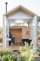 The barn-style front doors stay open during warmer months, giving a view of Eugenia’s garden. A floating desk, Hay Design coffee table, and separate couch offer additional seating in the downstairs area.