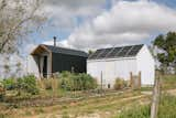 Spanish couple Eugenia Diaz and Pepe Moreno designed and built an off-grid tiny cabin and complementary workspace on a property they purchased in rural Portugal. They documented the experience and shared it on their YouTube channel to inspire others to do the same.  Photo 2 of 13 in My House: A Roaming Couple Settle Down by DIYing a Tiny Cabin for Less Than $10K from 10 Cabins, Campers, and Trailers We Dreamed of Escaping to in 2022