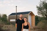 Pepe and Eugenia pose in front of the finished cabin on their property in Alentejo.