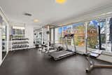 The lower level holds a spacious fitness room with free weights and workout machinery.&nbsp;
