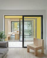 "The CLT panels have been insulated, coated in textural render, and painted a bold banana yellow to form a stepped rear extension and cubic front porch," says Unknown Works. "The yellow additions are tempered by gently rounded edges to bring a softness to their overall form, and stainless steel rain chains—a traditional Japanese guttering option—negate any visual clutter caused by downpipes."