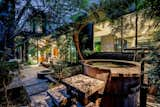 A verdant oasis awaits in the backyard, complete with a bespoke jacuzzi and jetted pool.  Photo 9 of 10 in Every Day Feels Like Vacation at This Marmol Radziner Stunner