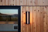 A Ravenhill Studio sconce hangs on the exterior siding.
