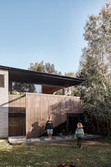 Flooding is a constant threat in subtropical New South Wales, so Casey Johnston (pictured, with sons Raph and Ozzy) and husband Martin asked architect Justin Twohill to design a backyard house that could weather a downpour with minimal cleanup.