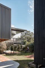 The couple chose hardy materials such as concrete blocks and galvanized steel and raised the floor 1.9 meters to keep the new build safe. The sleek, charred-wood cladding is an additional flood-resilience measure.  Photo 2 of 13 in Smart Design Saved This Backyard House From a Devastating Flood