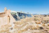 The hand-built ruggedness of the earthship complements the scruffy, rock-strewn terrain of the mesa. The skylights are operable and, when open, pull warm air out, working in concert with the huge thermal mass built into the earthship to provide passive HVAC.