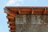 Three of the house’s walls are finished in cork on the lower level, and the upper portion of all the walls is clad in poplar bark from lumber cut in the Appalachian Mountains. The bark would typically have been a waste product in the timber-harvesting process.
