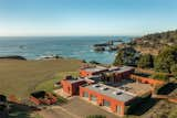 Here is an aerial view showcasing the property's multi-car garage, front courtyard, and close proximity to the Pacific Ocean.