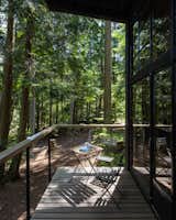 The ipe-wood deck on the east side of the cabin extends the living space in the summertime. The windows, salvaged from a property in Seattle, were given to Carsten by a friend.