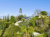 A long, gated driveway leads to the property, which perched on half an acre in Studio City. The lush landscaping helps creates a remote oasis.