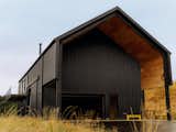Architect Jai Kumaran and his partner, Lindsay Merkle, transformed a badly neglected ridgetop property in Scappoose, Oregon, into a retreat, completing a 3,000-square-foot prefabricated workshop and studio suite as the first phase of a larger planned creative compound where they could live, work, and gather with family and friends.
