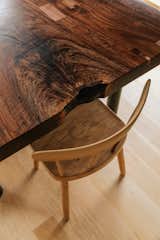 Light wood chair at dark-stained wood table.
