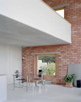 The bricks are joined with a red-tinted grouting to give the interior a sense of warmth despite the industrial material palette.