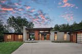 The site and existing driveway were minimally disturbed while relocating the garage and opening up the horizontal sight lines.  Photo 10 of 11 in These Five Homes Get a Fresh Outlook With Custom Windows and Doors from This Light-Filled Renovation Is Nestled Among the Trees in Minnesota