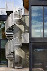 A stainless steel spiral staircase connects the pool level to the roof deck where the homeowners can remember about the cloud forests of Ecuador.