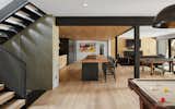 The ground pool level of the house features a game room, entertaining area, wet bar and gym for the young family of five.