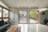 "Signature window walls and patio doors seamlessly connect the indoors and out," notes the agent. The post-and-beam ceiling is painted a crisp shade of white.