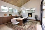 "The open kitchen/dining room was designed as much for everyday use as it was for editorial spreads, with an astounding amount of storage and work space, a matte brass range hood perched above dual ovens, and a custom semi-oval island whose facade alludes to the exterior of the home,