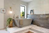 Spanning the entire second floor, the suite includes a large walk-in closet and a spa-inspired bath, complete with a Bodelair concrete soaking tub and glass shower.