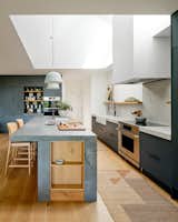 The design team specified durable, easy-to-maintain, nontoxic, recyclable, natural, and regenerative materials. The kitchen island is engineered quartz, and the cabinets are from a local cabinetmaker.