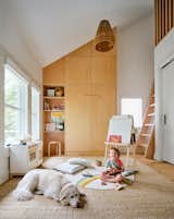 The living room once had low ceilings, but moving the insulation to the roof plane allowed for dramatic plays of volume and light.  Photo 15 of 22 in storage by Nicolette VILJOEN from Budget Breakdown: An Austin Couple Give a Century-Old Craftsman a Passive House Upgrade for $836K