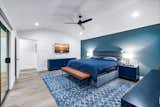 Touches of blue continue into the primary bedroom which offers direct outdoor access.