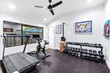 A spacious workout room is conveniently located near a basketball pad in the backyard.&nbsp;