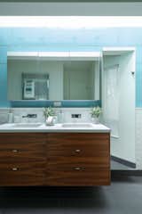 Icy blue tile provides a pop of color in one of the home’s four bathrooms.