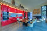 Glossy red cabinets make a statement in the open-concept kitchen.