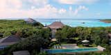 In addition to the main residence, the island boasts four guesthouses and an array of amenities, including a private helipad, an Olympic-length infinity pool, and a spa.