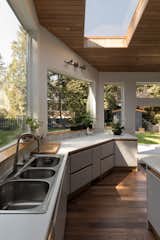 A large skylight and picture windows allow the airy kitchen to be naturally lit with sunshine.