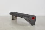 FIRE OPENS STONE share its material palette with BIRTH AT DAWN, with a slab of Nero Africa granite hewn into a bench that’s propped up with concrete at one end.