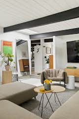Black accents continue inside, where an open layout merges the living areas.