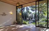 Gillian’s yoga studio is lit by sconces from Oly Studio and a vintage lotus pendant by Feldman Lighting. The magnolia in the garden beyond provides ample shade.