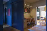 Bestor set an office between the dining area and the TV room. The hand-knotted rug is by Wallace Sewell, and the chairs are from A+R.