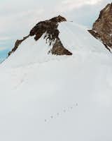 Mountaineers appear tiny as they climb the Monte Rosa massif.&nbsp;