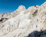 Mountaineers scale cliff in the Pennine alps to reach bivacco Giusto Gervasutti, an mountain encampment